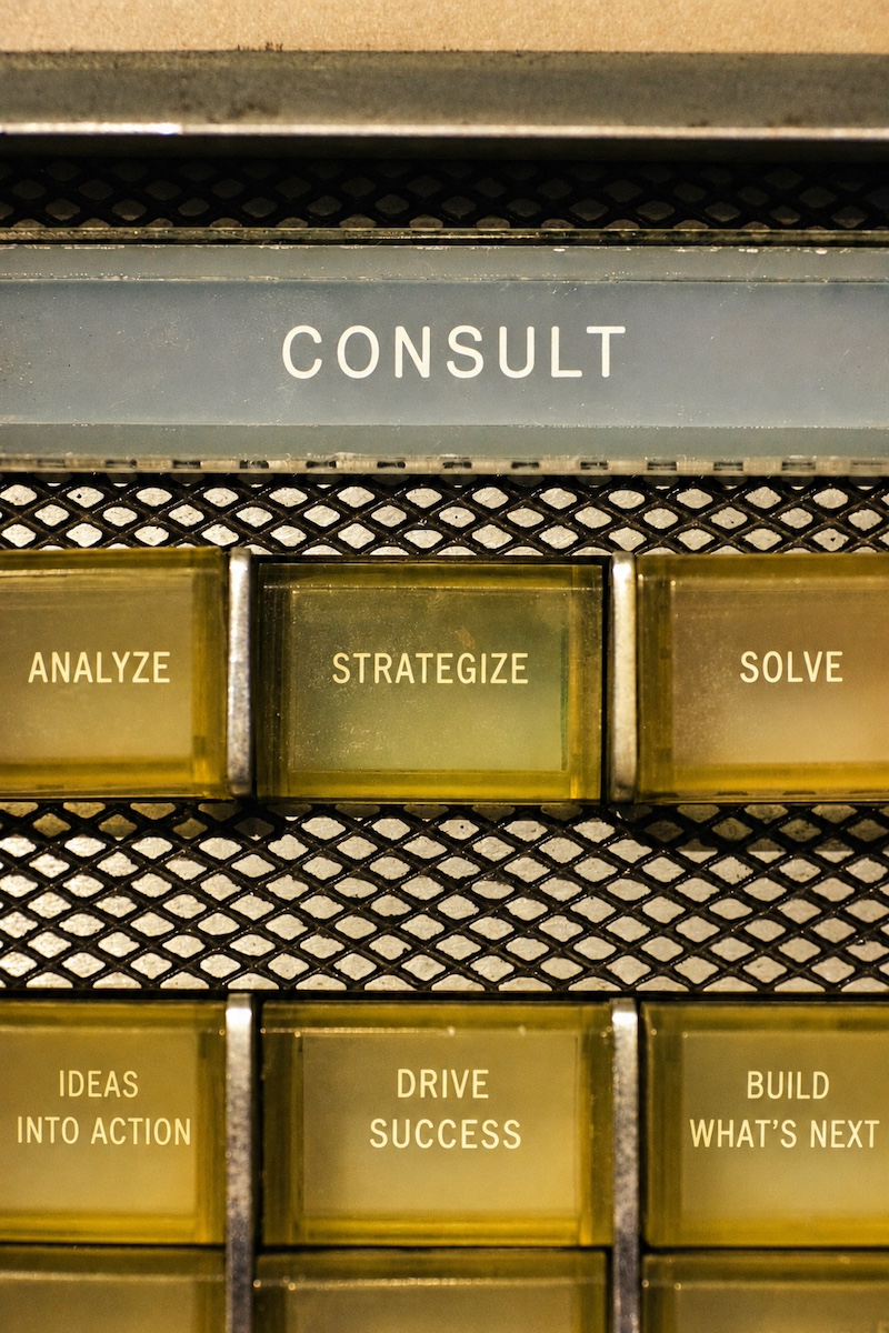 Vintage consulting switchboard with buttons reading analyze, strategize, and solve