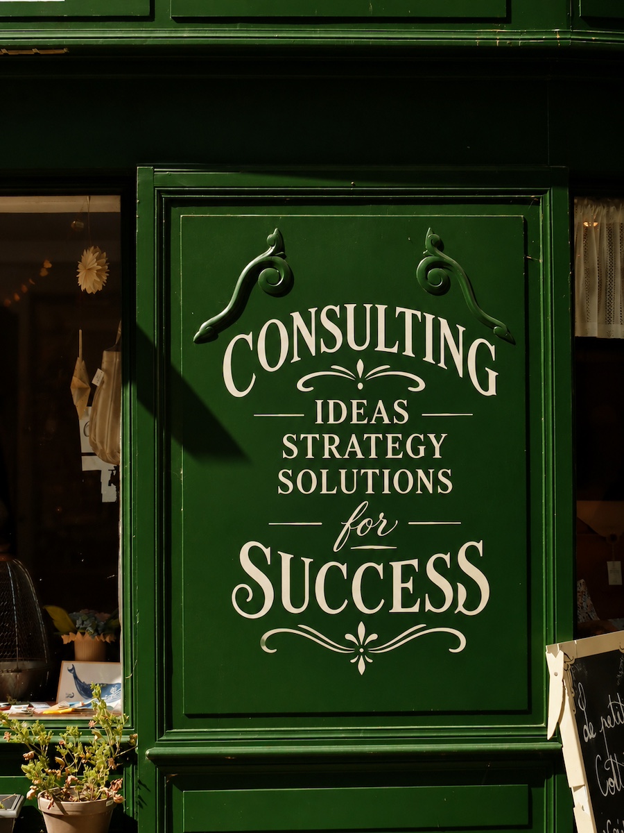 Hand-lettered green storefront sign for ideas, strategy, and solutions